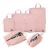 Pink travel packing cube set with shoe and toiletry bags.