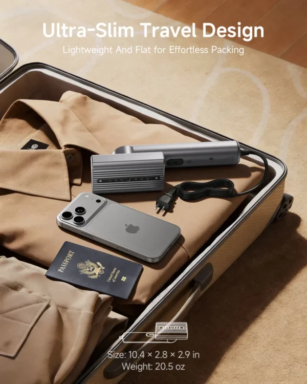 Ultra-slim portable travel garment steamer packed in suitcase with shirt, iPhone, and passport.
